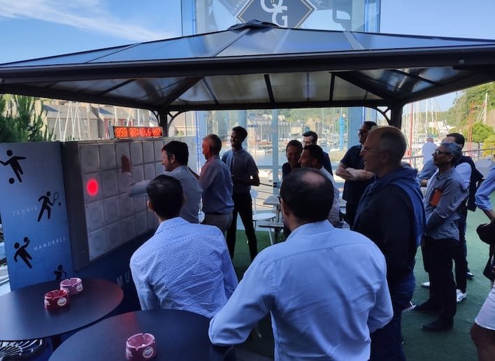 Groupe de collègues jouant au mur digital ors d'un team building